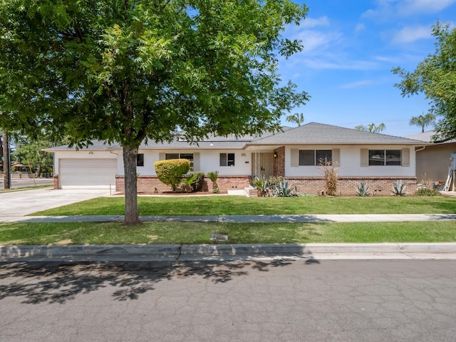 6413 N 5th St, Fresno, CA 93710 - ranch-style house featuring brick siding, concrete driveway, a front yard, and an attached garage