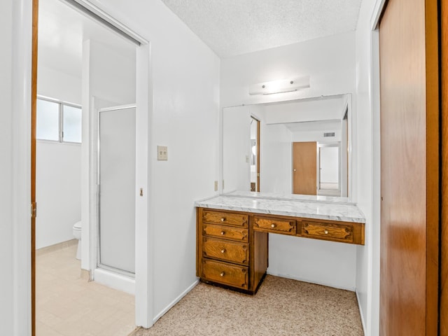 6413 N 5th St, Fresno, CA 93710 - full bath with a shower stall, toilet, vanity, a textured ceiling, and baseboards