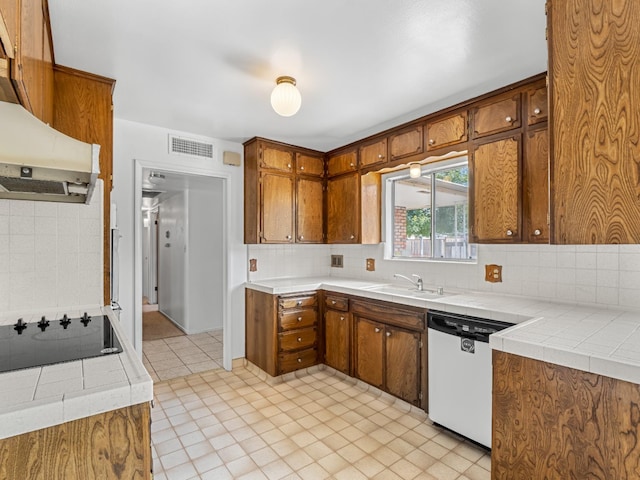 6413 N 5th St, Fresno, CA 93710 - kitchen with white dishwasher, black electric cooktop, a sink, and brown cabinetry