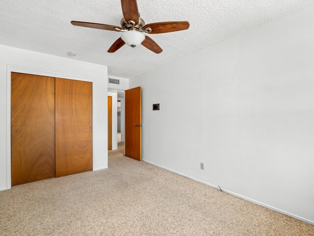 6413 N 5th St, Fresno, CA 93710 - unfurnished bedroom featuring carpet flooring, a closet, a textured ceiling, and ceiling fan