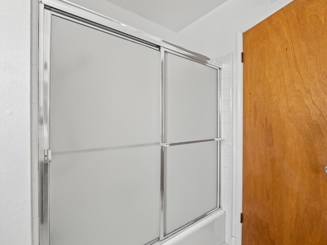 6413 N 5th St, Fresno, CA 93710 - bathroom featuring bath / shower combo with glass door