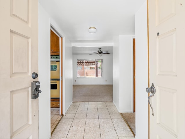 6413 N 5th St, Fresno, CA 93710 - hall with light colored carpet, light tile patterned floors, and baseboards
