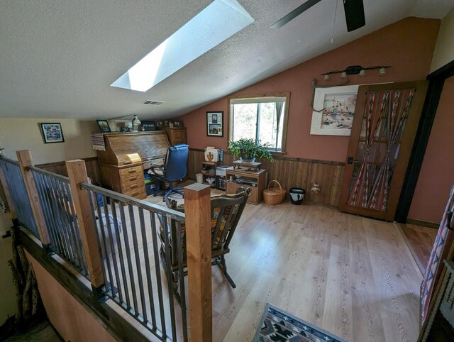 51410 Wildmint Ln, Yokuts Valley, CA 93675 - office space featuring a skylight, wood finished floors, lofted ceiling, ceiling fan, and a wainscoted wall