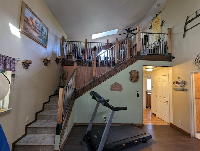 51410 Wildmint Ln, Yokuts Valley, CA 93675 - exercise area featuring a skylight, wood finished floors, a towering ceiling, and baseboards