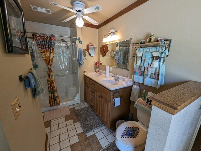 51410 Wildmint Ln, Yokuts Valley, CA 93675 - full bathroom featuring a stall shower, double vanity, a ceiling fan, toilet, and tile patterned flooring