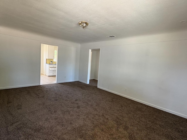 4664 E Browne St, Fresno, CA 93703 - unfurnished room with carpet flooring, baseboards, and a textured ceiling