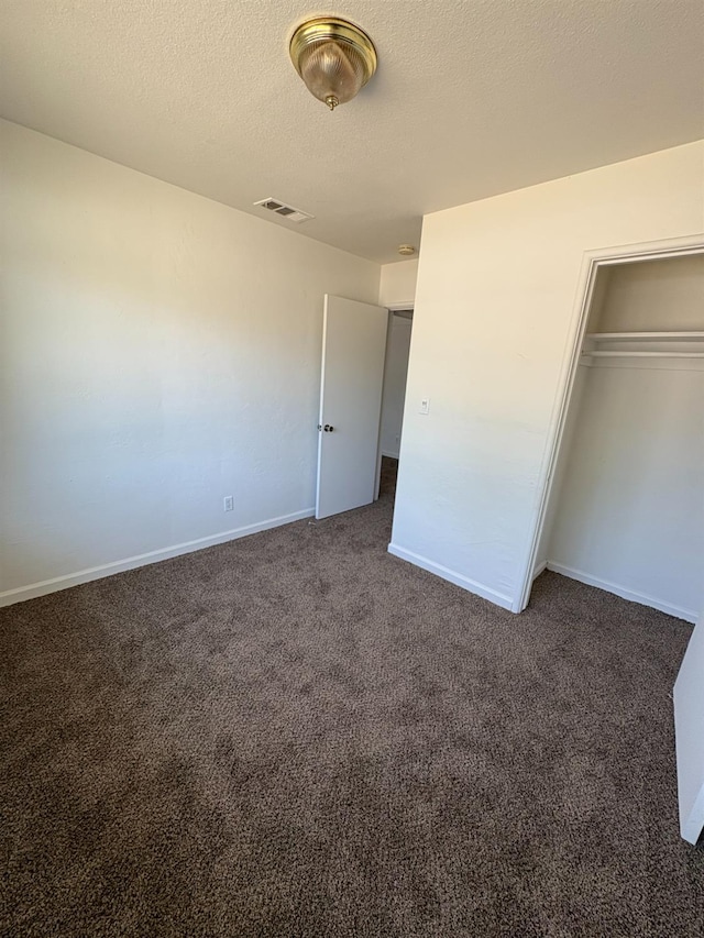 4664 E Browne St, Fresno, CA 93703 - unfurnished bedroom featuring carpet flooring, a closet, baseboards, and a textured ceiling