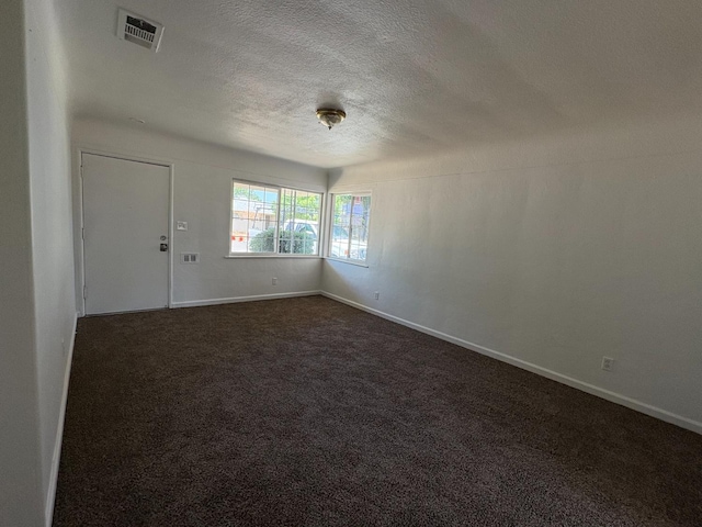 4664 E Browne St, Fresno, CA 93703 - spare room featuring a textured ceiling, dark carpet, and baseboards