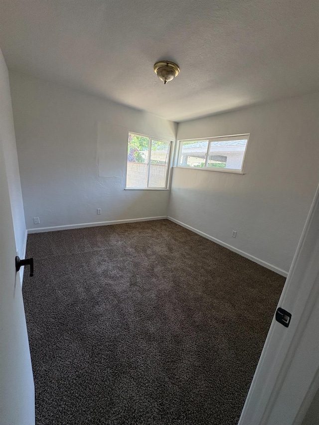 4664 E Browne St, Fresno, CA 93703 - unfurnished room with dark colored carpet and baseboards