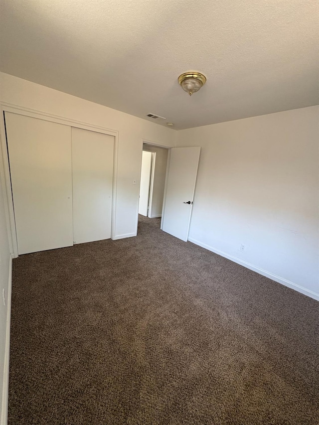 4664 E Browne St, Fresno, CA 93703 - unfurnished bedroom with dark carpet, baseboards, and a closet
