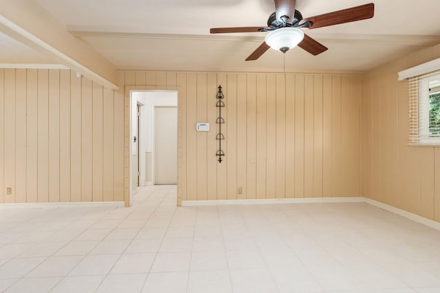 5835 E Hamilton Ave, Fresno, CA 93727 - empty room with a ceiling fan, tile patterned floors, and wooden walls