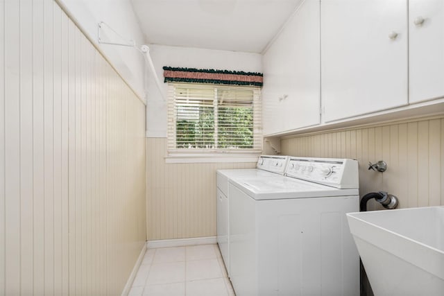 5835 E Hamilton Ave, Fresno, CA 93727 - laundry area featuring washer and dryer, cabinet space, light tile patterned floors, wainscoting, and wooden walls