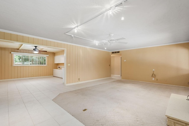 5835 E Hamilton Ave, Fresno, CA 93727 - spare room with rail lighting, baseboards, ornamental molding, a ceiling fan, and wooden walls
