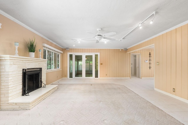5835 E Hamilton Ave, Fresno, CA 93727 - unfurnished living room with crown molding, a ceiling fan, a fireplace with raised hearth, baseboards, and track lighting