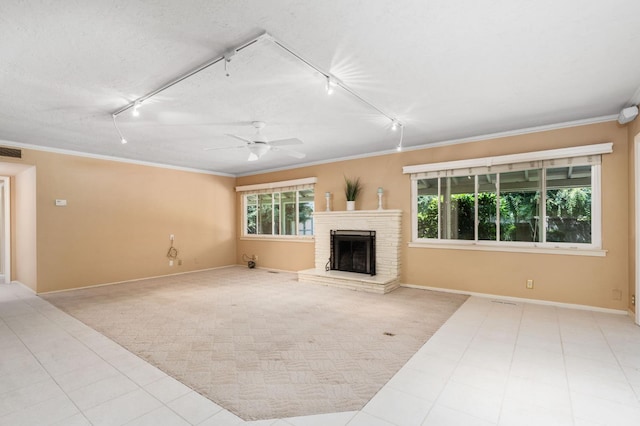 5835 E Hamilton Ave, Fresno, CA 93727 - unfurnished living room with track lighting, ornamental molding, baseboards, a fireplace, and ceiling fan
