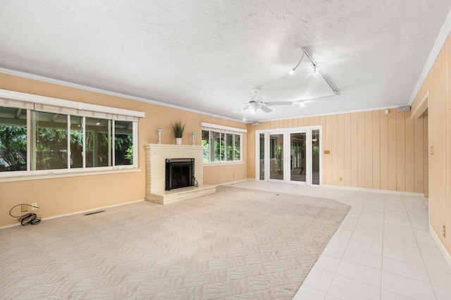 5835 E Hamilton Ave, Fresno, CA 93727 - unfurnished living room featuring ceiling fan, baseboards, crown molding, a brick fireplace, and rail lighting