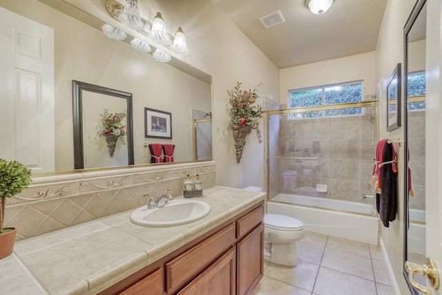 1223 E Rosemont Ln, Fresno, CA 93730 - bathroom with vanity, tile patterned flooring, toilet, shower / bath combination with glass door, and tasteful backsplash