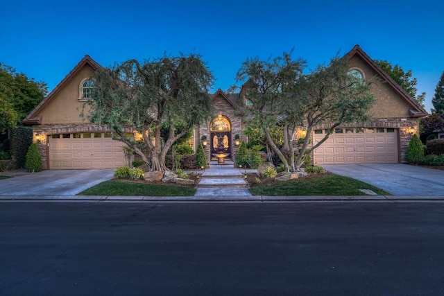 1223 E Rosemont Ln, Fresno, CA 93730 - view of front of home with driveway, stucco siding, and stone siding