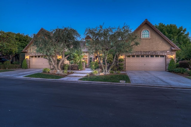 1223 E Rosemont Ln, Fresno, CA 93730 - view of front of home with concrete driveway, stone siding, and stucco siding