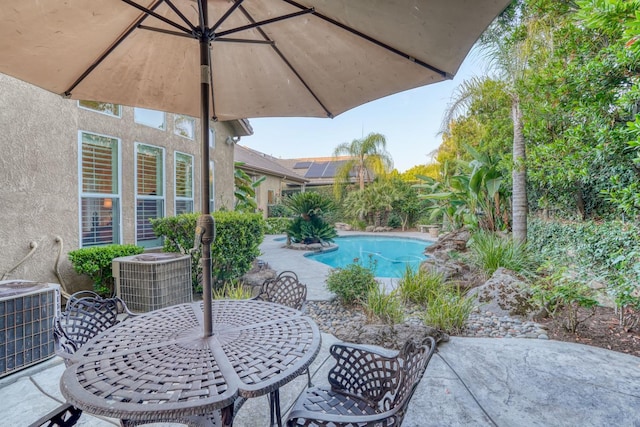 1223 E Rosemont Ln, Fresno, CA 93730 - view of patio featuring central air condition unit, outdoor dining area, and an outdoor pool
