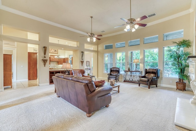 1223 E Rosemont Ln, Fresno, CA 93730 - living room with light carpet, crown molding, ceiling fan, a high ceiling, and baseboards