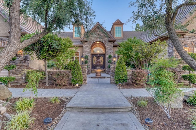 1223 E Rosemont Ln, Fresno, CA 93730 - view of front of house featuring stucco siding, stone siding, and a tiled roof