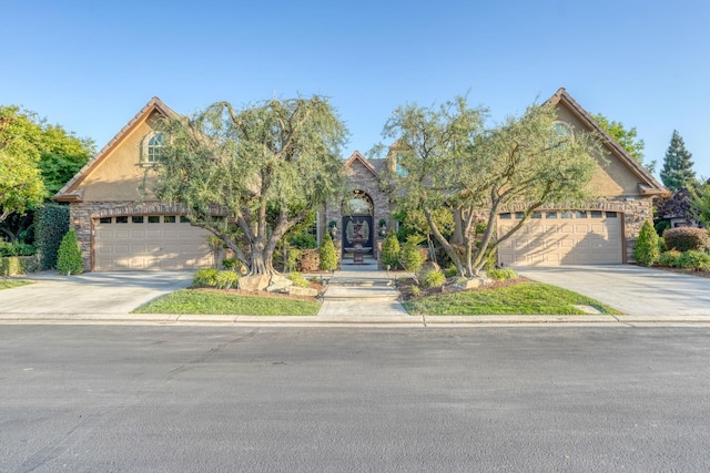 1223 E Rosemont Ln, Fresno, CA 93730 - obstructed view of property with concrete driveway and stone siding