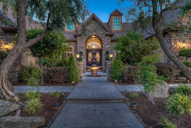 1223 E Rosemont Ln, Fresno, CA 93730 - view of exterior entry featuring stone siding and stucco siding