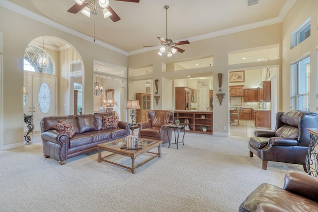 1223 E Rosemont Ln, Fresno, CA 93730 - living room with light colored carpet, ceiling fan, ornamental molding, a high ceiling, and baseboards