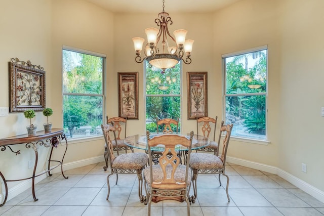 1223 E Rosemont Ln, Fresno, CA 93730 - dining space featuring a chandelier, light tile patterned floors, baseboards, and a towering ceiling