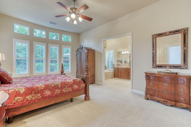 1223 E Rosemont Ln, Fresno, CA 93730 - bedroom featuring light colored carpet, multiple windows, baseboards, and ensuite bath