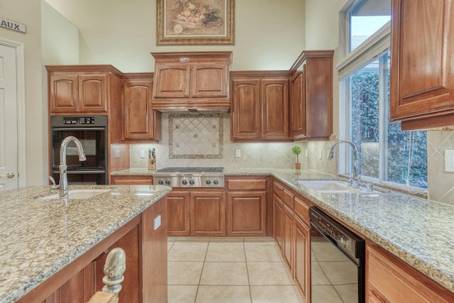 1223 E Rosemont Ln, Fresno, CA 93730 - kitchen featuring black appliances, a sink, light stone countertops, light tile patterned floors, and decorative backsplash