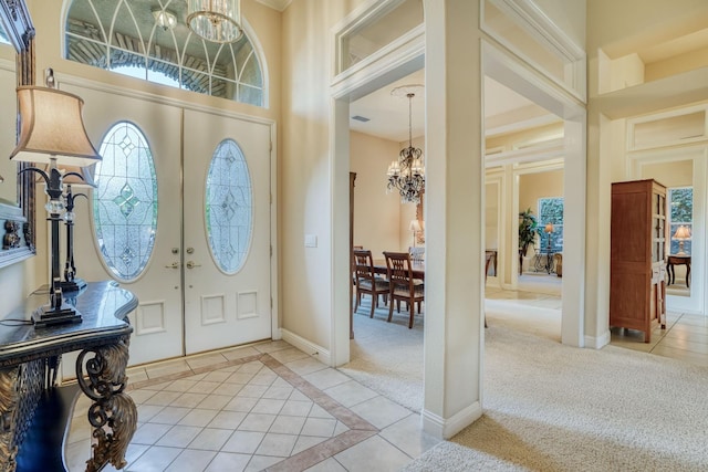 1223 E Rosemont Ln, Fresno, CA 93730 - foyer featuring a chandelier, plenty of natural light, light tile patterned floors, a towering ceiling, and baseboards