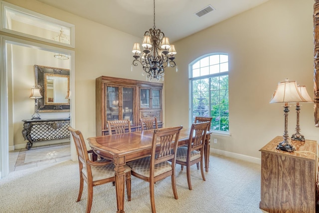 1223 E Rosemont Ln, Fresno, CA 93730 - dining area with light carpet, baseboards, and a chandelier