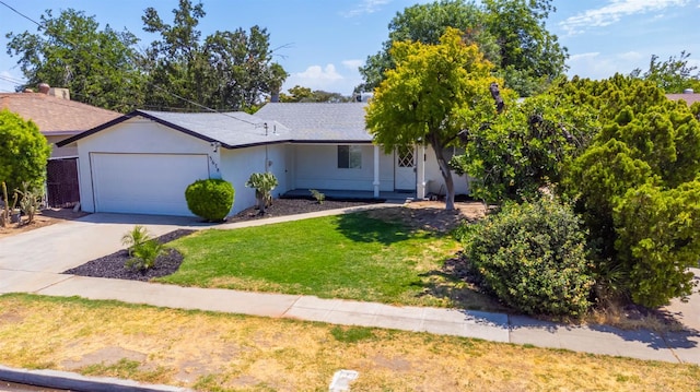 3678 N 7th St, Fresno, CA 93726 - ranch-style home featuring a garage, a front yard, concrete driveway, and stucco siding