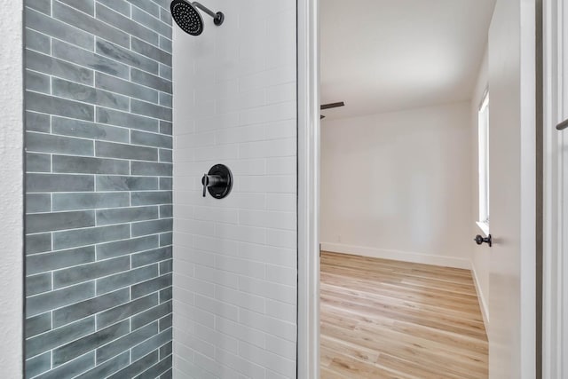 3678 N 7th St, Fresno, CA 93726 - full bath with a tile shower, wood finished floors, and baseboards