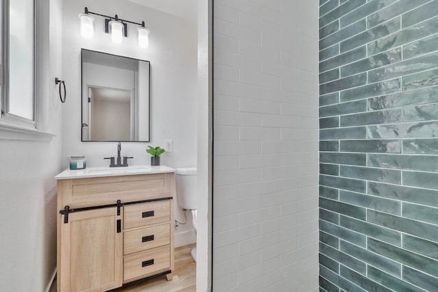 3678 N 7th St, Fresno, CA 93726 - bathroom featuring toilet, vanity, and wood finished floors