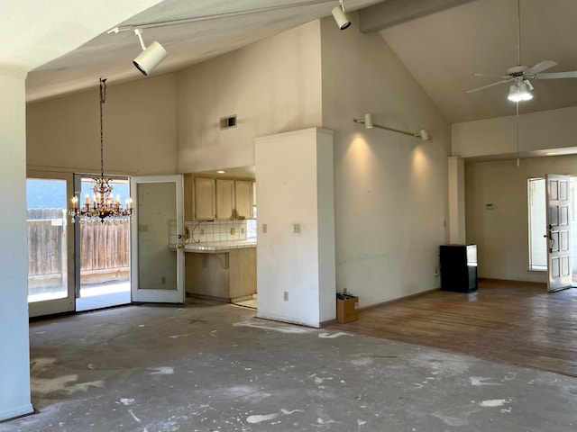 5092 W Stuart Ave, Fresno, CA 93722 - unfurnished living room with high vaulted ceiling, a ceiling fan, and a chandelier