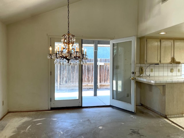 5092 W Stuart Ave, Fresno, CA 93722 - unfurnished dining area featuring high vaulted ceiling, concrete flooring, and a chandelier