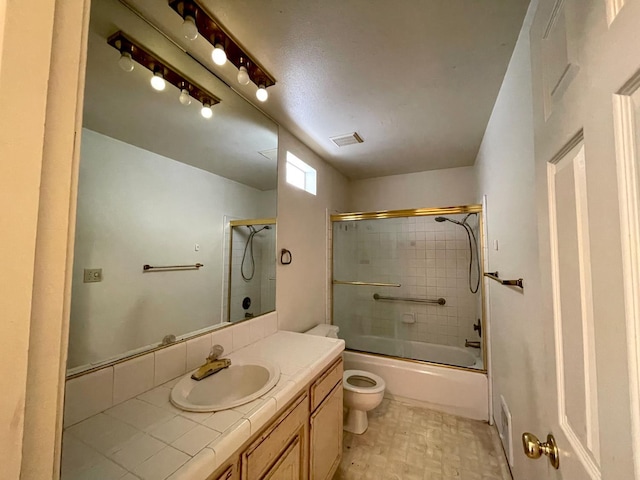 5092 W Stuart Ave, Fresno, CA 93722 - full bath featuring vanity, toilet, and combined bath / shower with glass door