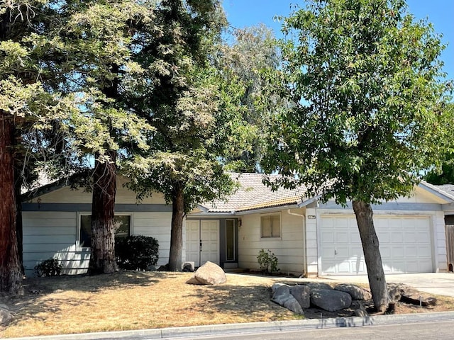 5092 W Stuart Ave, Fresno, CA 93722 - view of front of house with driveway and a garage