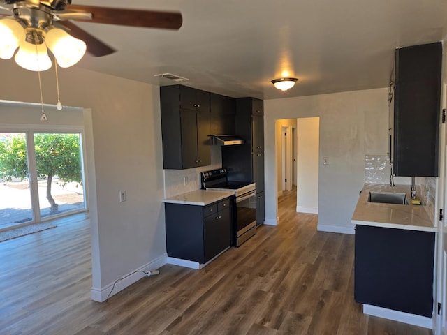 2018 E Pico Ave, Fresno, CA 93726 - kitchen featuring stainless steel electric range oven, dark cabinetry, light countertops, a sink, and baseboards