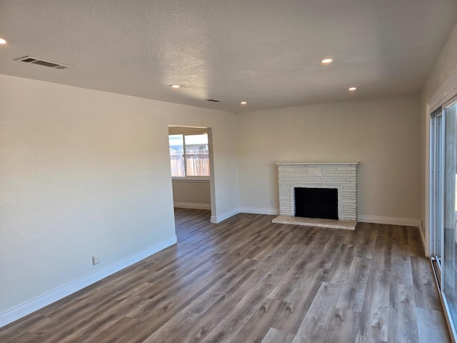 2018 E Pico Ave, Fresno, CA 93726 - unfurnished living room featuring wood finished floors, baseboards, recessed lighting, a fireplace, and a textured ceiling