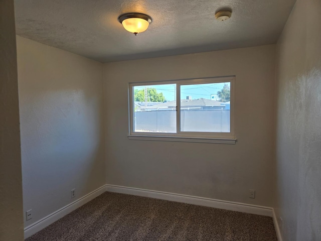 2018 E Pico Ave, Fresno, CA 93726 - unfurnished room with baseboards, dark colored carpet, and a textured ceiling