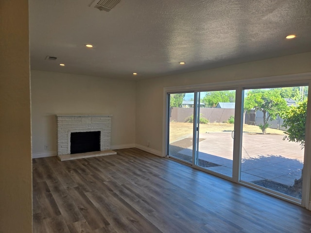 2018 E Pico Ave, Fresno, CA 93726 - unfurnished living room featuring baseboards, dark wood-style floors, recessed lighting, and a fireplace with raised hearth