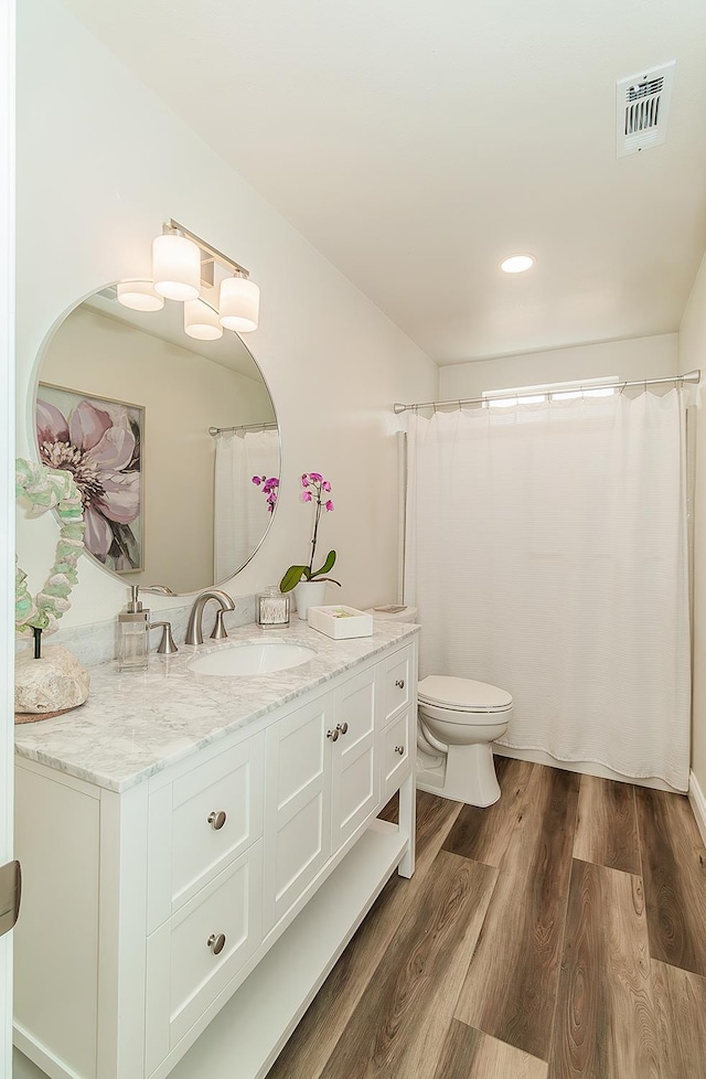 736 N Dartmouth Ave, Clovis, CA 93611 - bathroom with vanity, toilet, wood finished floors, and recessed lighting