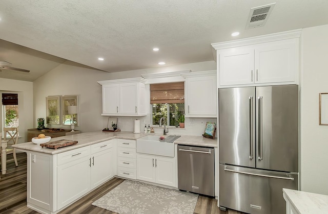 736 N Dartmouth Ave, Clovis, CA 93611 - kitchen with stainless steel appliances, a sink, white cabinets, a peninsula, and recessed lighting