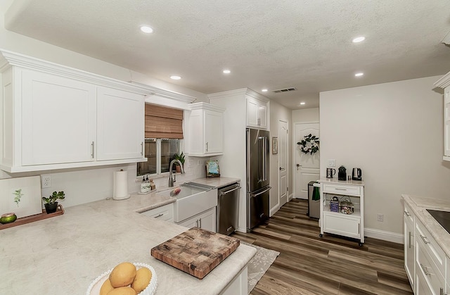 736 N Dartmouth Ave, Clovis, CA 93611 - kitchen featuring appliances with stainless steel finishes, decorative backsplash, white cabinetry, a sink, and recessed lighting