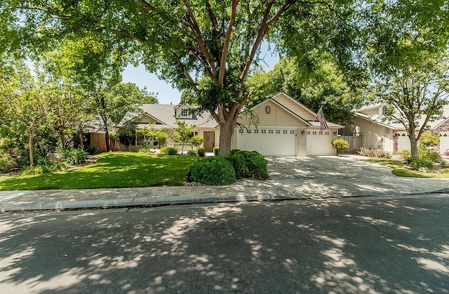 736 N Dartmouth Ave, Clovis, CA 93611 - view of property hidden behind natural elements with an attached garage and concrete driveway