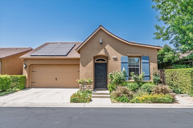 3675 Trenton Ln, Clovis, CA 93619 - view of front of home with stucco siding, solar panels, a garage, and driveway
